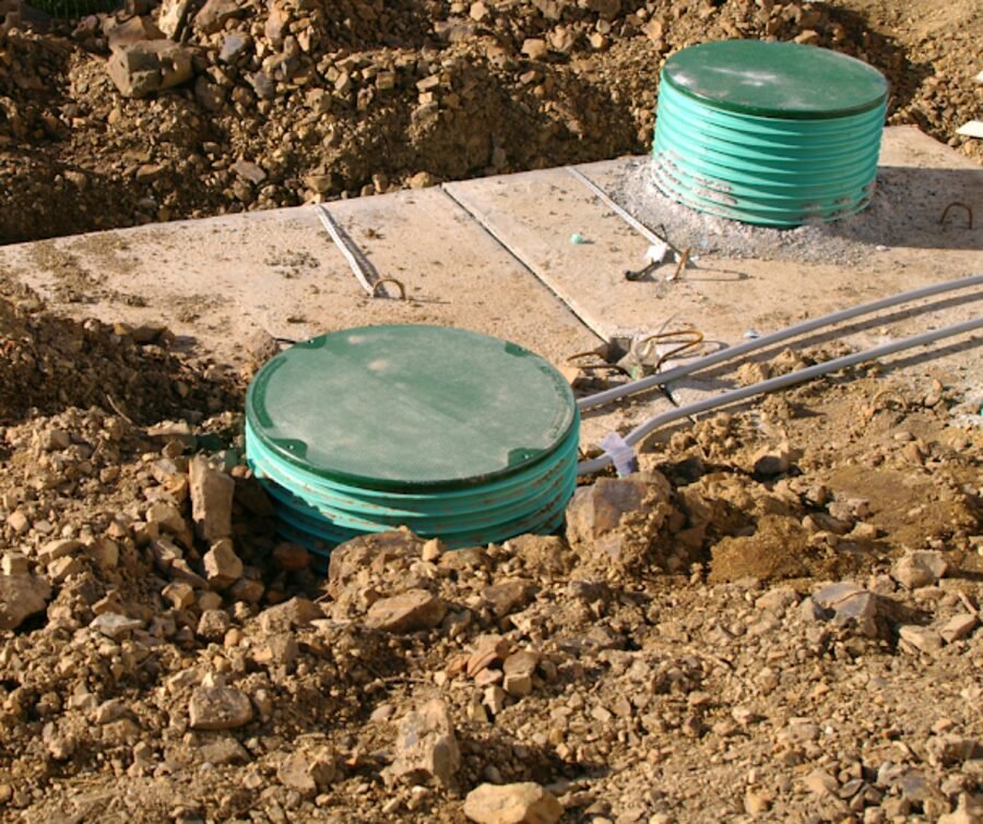 New septic tank risers set in the ground during an install.