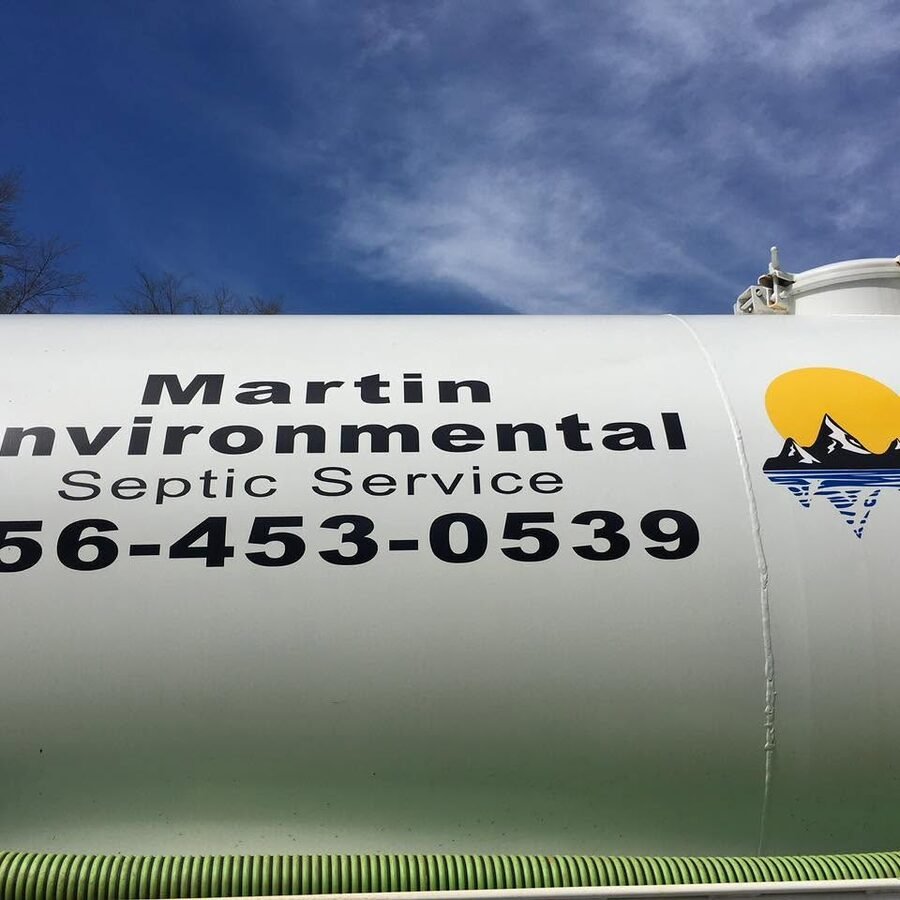 The Martin Environmental Septic Service pump truck, lettered with the company name and phone number.